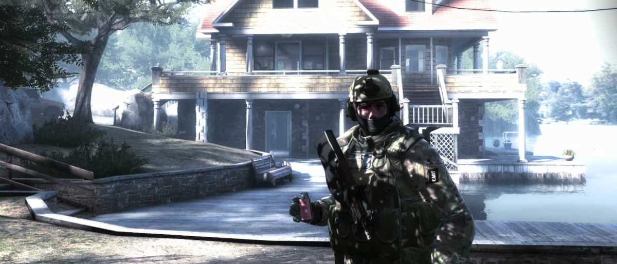Photo of a house in CS:GO. There's a soldier in front of the house.
