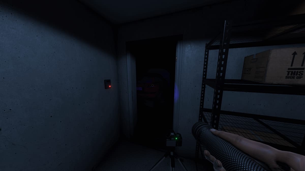 Phasmophobia screenshot of a camera pointing to a doorway leading to a dark room.