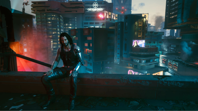 Johnny Silverhand sitting on the edge of a roof in front of many Night City Skyscrapers in Cyberpunk 2077.