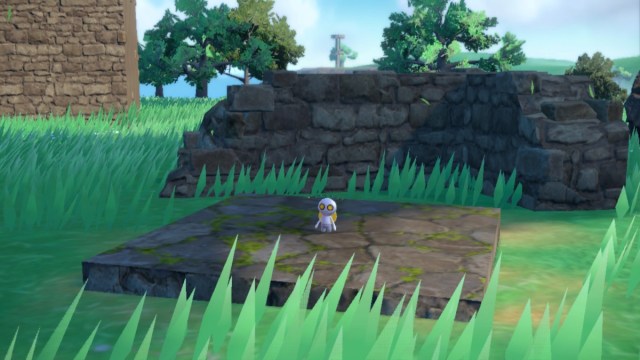 Screenshot of roaming Gimmighoul standing on some Ruins in Pokemon Scarlet and Violet.