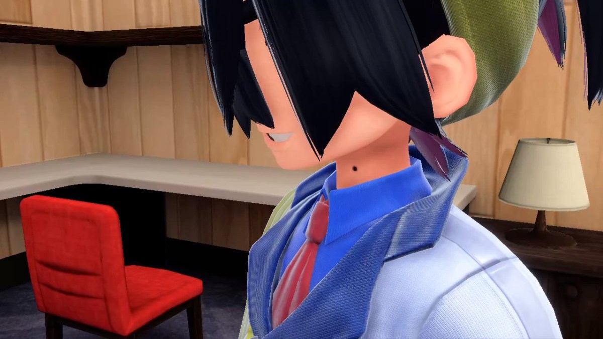 A Pokémon Scarlet & Violet: The Teal Mask screenshot of Kieran, whose eyes are covered by his hair, looking ominous.