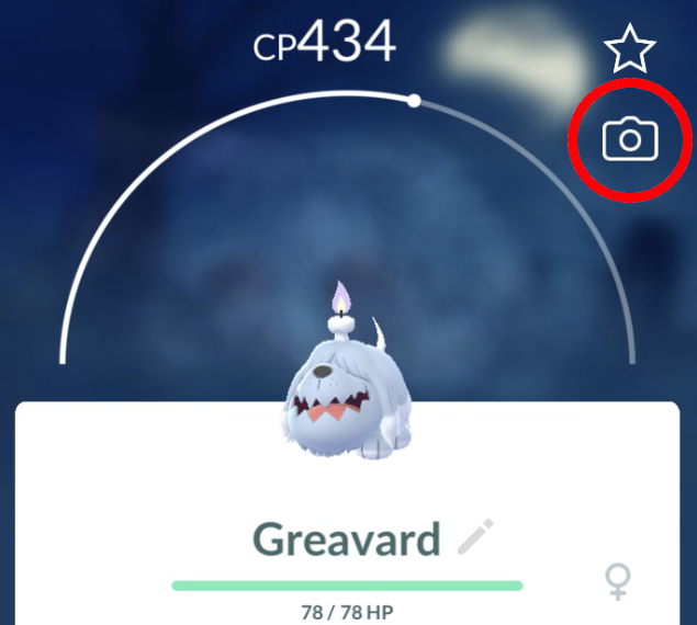A Pokémon GO screenshot of a Greavard's information page. The camera icon in the upper right, which takes players to the snapshot feature, is circled in red.