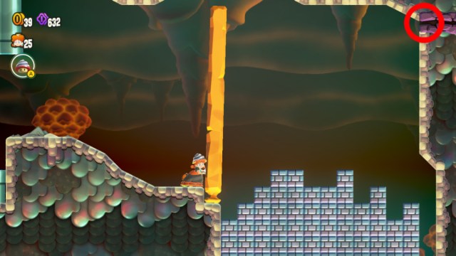 A Super Mario Bros. Wonder screenshot of Drill Daisy pushing a wall. A crevice leading to a secret exit in the upper right corner is circled in red.