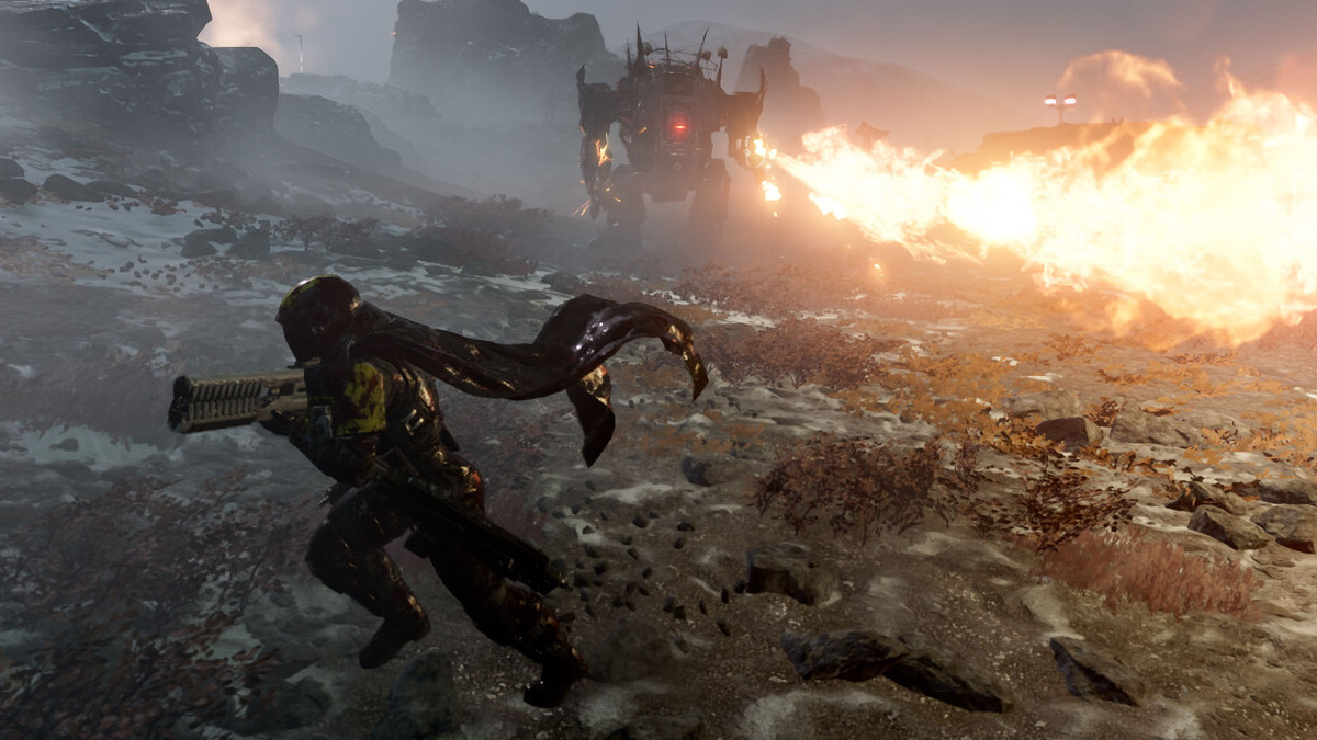 Helldivers 2 screenshot of a player character running while a robot shoots flames in the background
