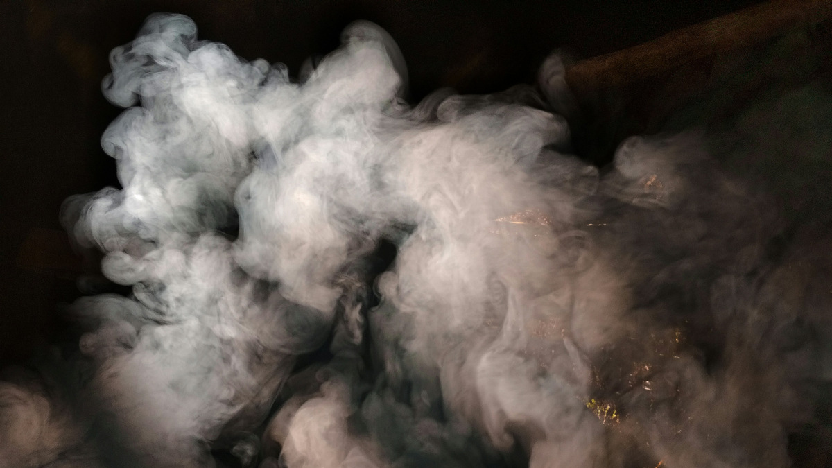 A photograph of smoke against a black background.