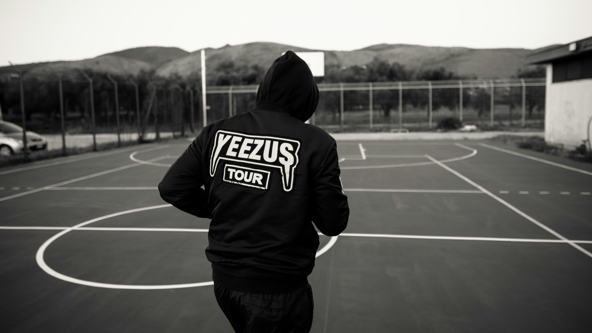 A photograph of a person in a Kanye West Yeezus Tour hoodie.