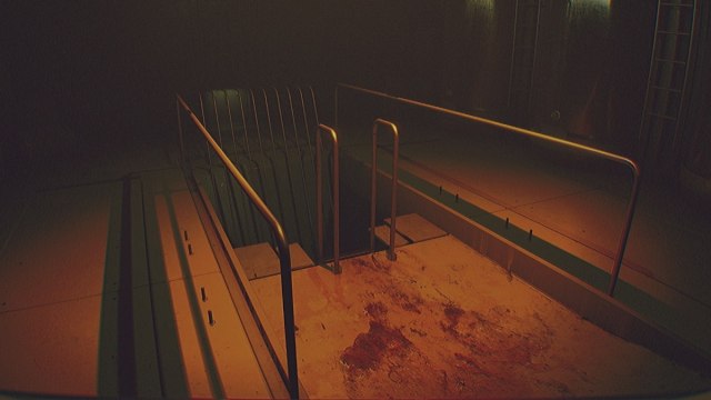 Routine ladder leading down to an area with red room