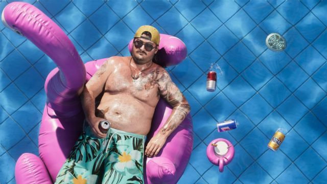 Cal Hampton lazing in the pool on a floating ring.